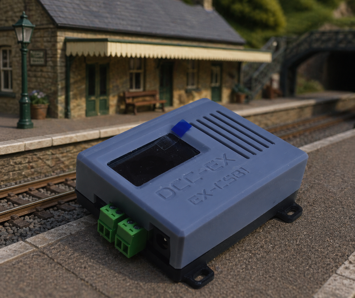 DCC-EX CSB1 command station installed on a model railway layout at a realistic station platform with track and scenery